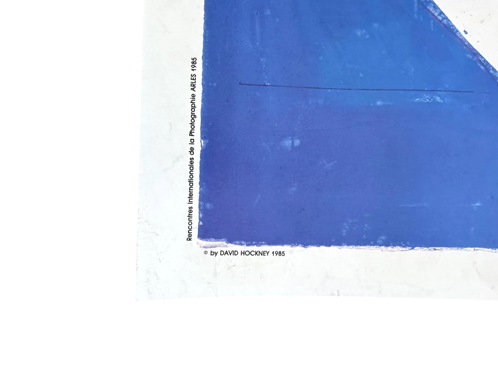 David Hockney lithograph titled Rencontres International de la Photographie, Arles 1985, depicting vibrant artistic imagery.