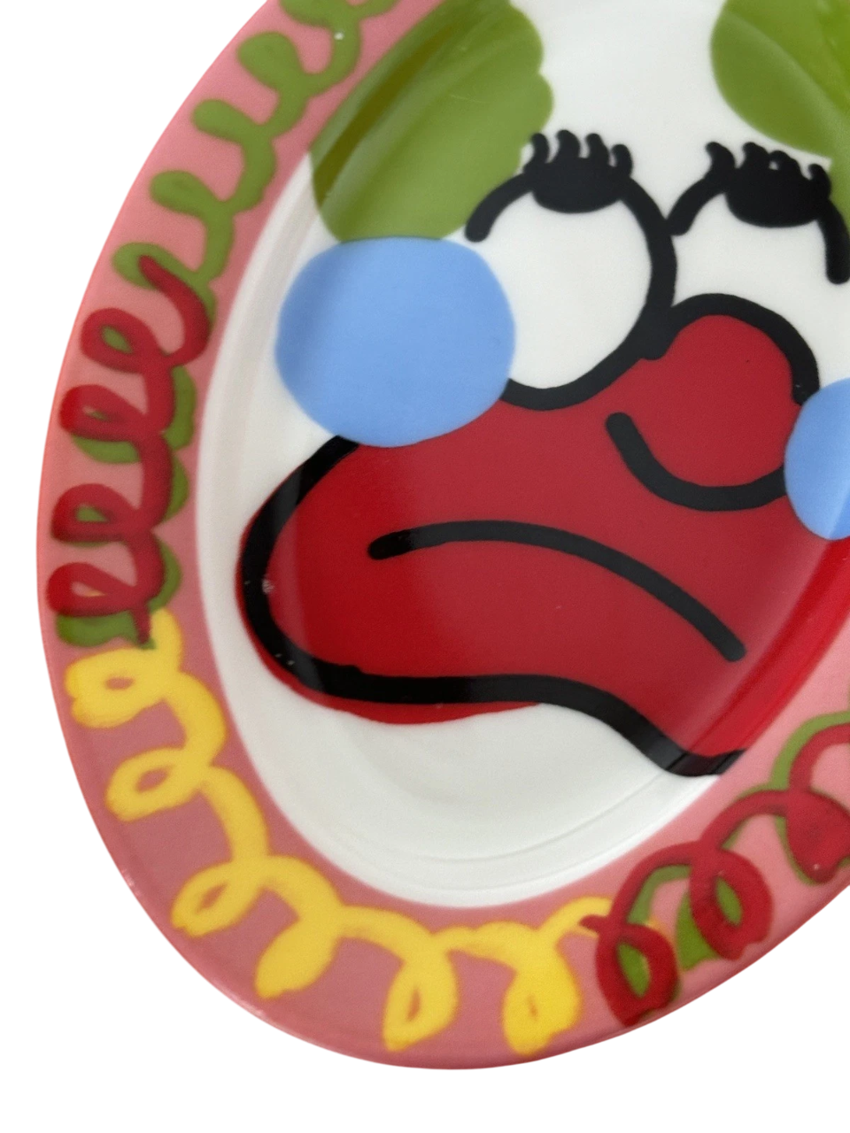 Hand-painted clown design on a decorative plate by SLAWN, showcasing vibrant colors and intricate details.