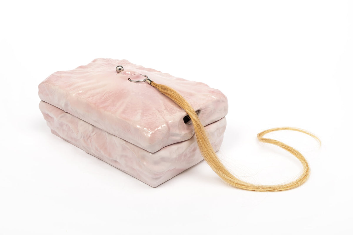 Sun Woo, Memory Box, 2021. Pink resin box with synthetic blonde hair.