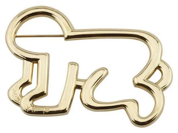 18kt gold baby pin featuring KEITH HARING's signature design, showcasing vibrant colors and playful shapes.